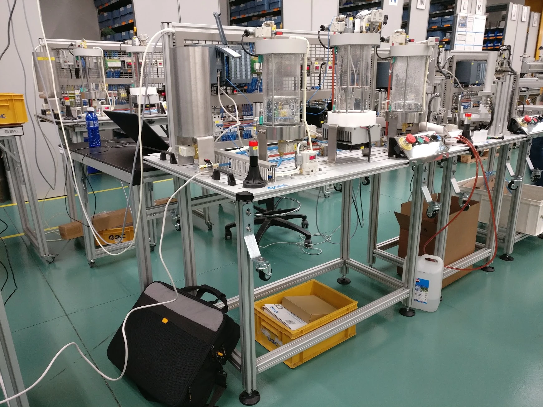 IPC process-control stations with transparent vessels, Siemens PLC hardware and operator panels at SMC’s factory in Vitoria, Spain.