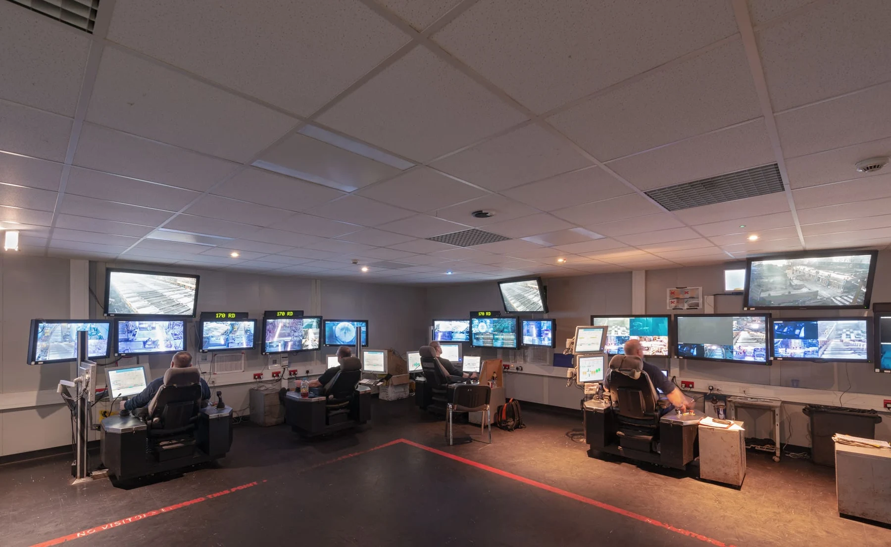 Operators at control desks facing multiple process and camera displays in the Stocksbridge control room.