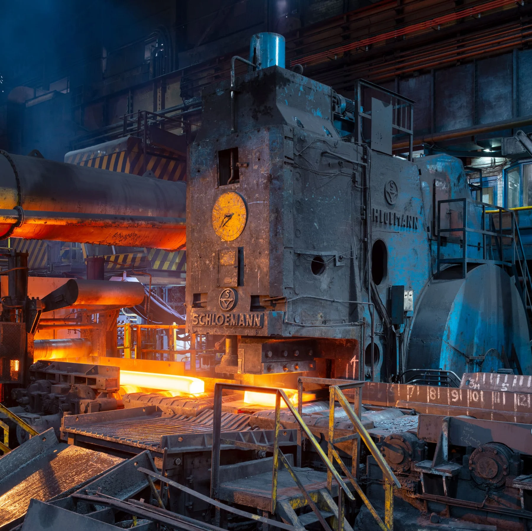 Heavy industrial shears beside a glowing steel section at Stocksbridge.